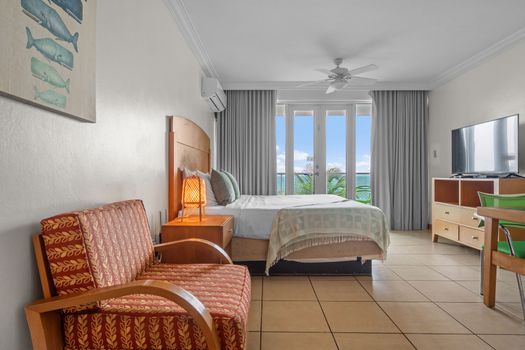 Wake up to paradise! Our inviting queen bed offers ultimate comfort, with direct balcony access and mesmerizing views of the Condado Lagoon