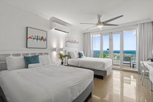 Spacious studio with two comfortable beds and a private balcony boasting stunning ocean views. Ideal for a luxurious getaway.