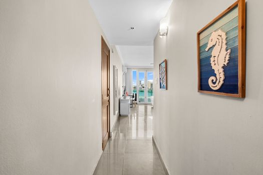 Be greeted by a charming entryway leading to breathtaking water views, setting the tone for an unforgettable stay. The seaside decor adds a touch of coastal charm.