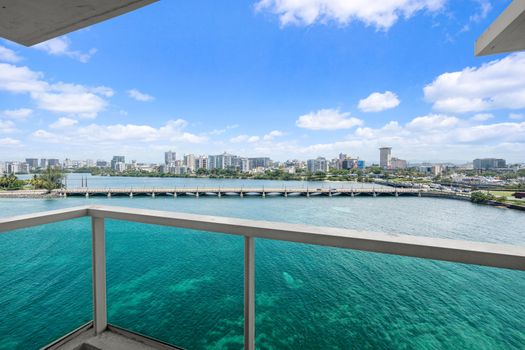 This breathtaking aerial perspective captures the essence of San Juan's coastal charm, from the calm lagoon waters to the distant ocean and the bustling cityscape. Experience the vibrant interplay of nature and urban life right from your window.