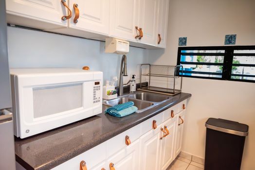 Enjoy the convenience of a dedicated kitchen workstation, complete with a microwave and all the essentials for cooking and tidying up after your culinary adventures.