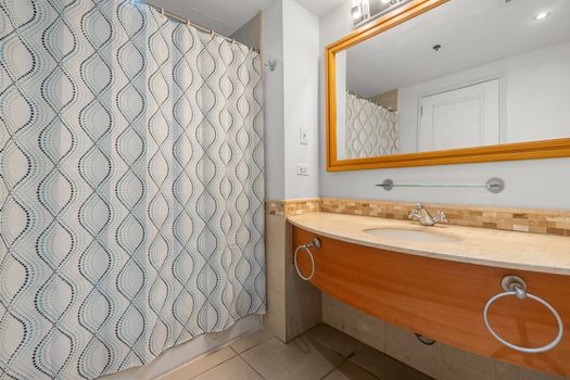 A pristine and functional bathroom awaits, offering a combination shower and tub. Tasteful design ensures a comfortable experience.