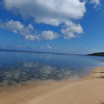 Escape to the serene beauty of the Malolos coast! This calm, clear water and sandy shore invite you to relax under a beautiful blue sky with soft, wispy clouds.