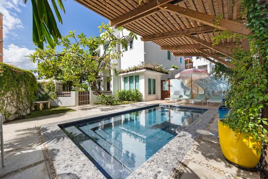 Experience outdoor bliss with a refreshing dip in your exclusive swimming pool.
