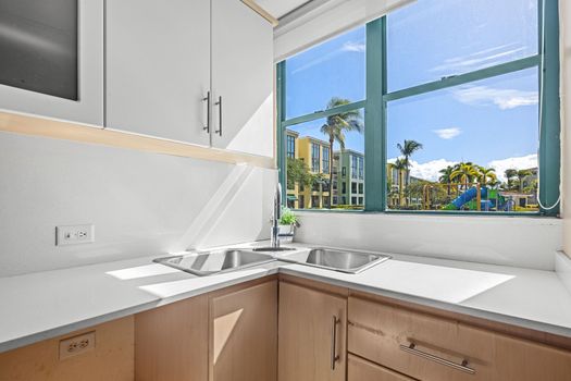 A clean, spacious kitchen featuring modern amenities and a breathtaking outdoor view.