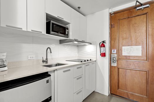 Sleek, modern kitchenette with all essentials, perfect for convenient meal prep during your stay.