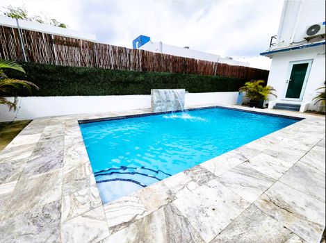 Dive into relaxation! Our sparkling clear pool awaits, surrounded by comfortable loungers perfect for soaking up the sun and enjoying the serene ambiance of your private getaway