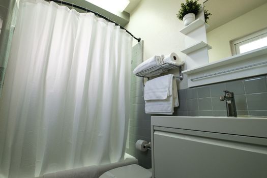 Our clean and well-maintained bathroom offers all the necessities, including a spacious shower area with easy access to fresh towels for your convenience.