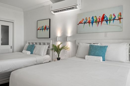 Sleep soundly in this comfortable bedroom with two perfectly arranged beds. Delightful artwork and soft lighting ensure a restful stay.