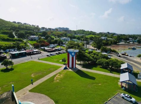 Experience Puerto Rico! Admire this impressive flag monument set against a bright, sunny backdrop.