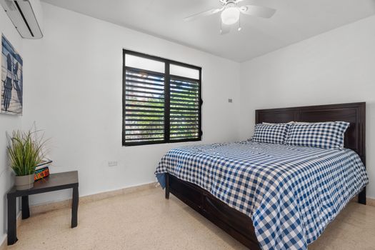 Coastal Dreams: Experience pure comfort in this inviting bedroom, featuring soothing blue accents and charming shutters for a tranquil atmosphere.