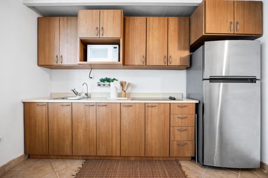 Cook your favorites in a kitchen with natural wooden cabinets, fridge, and all essentials provided.