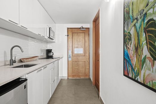 Enter a bright and welcoming space, where modern design meets practicality. Our sleek kitchenette, complete with essential appliances, is immediately accessible, making arrivals smooth and your stay effortlessly comfortable.