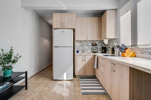 Fully Equipped Kitchen: Prepare your favorite meals in our bright and modern kitchen, featuring sleek wooden cabinetry, a full-sized refrigerator, and ample counter space for all your culinary adventures.