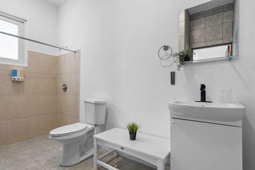 Refresh yourself in this pristine bathroom where contemporary aesthetics meet functionality.