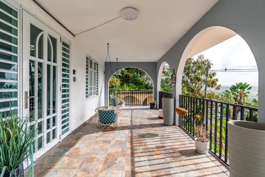 Spacious outdoor patio with unique, hanging swing chairs.