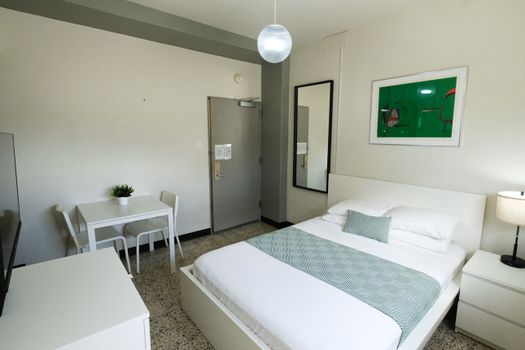 Relax and recharge in this charming bedroom offering a comfortable bed and a dedicated desk area, perfect for catching up on emails or planning your next adventure.