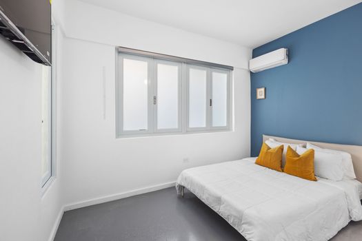 Sleek and stylish bedroom with a pop of blue.