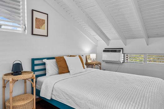 Unwind in a bright and airy bedroom featuring a plush bed, large window for natural light, and powerful AC – your perfect retreat after a day of exploring!