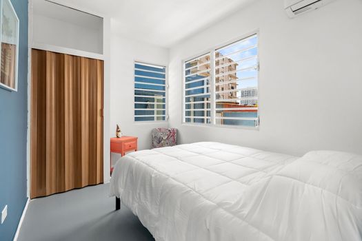 Wake up refreshed in this bright and airy room, where the morning light gently illuminates the crisp, white bedding and clean, minimalist design.