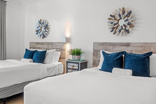 Your dream vacation starts here! This inviting bedroom features two comfortable beds and a direct connection to the beauty of the ocean, just steps from your private balcony.