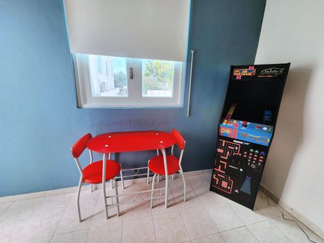 Savor your meals and enjoy pleasant conversations in this comfortable and inviting dining area. The vibrant red chairs add a touch of warmth, making it the perfect spot for memorable moments.
