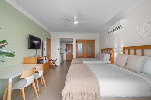 Perfect for families or friends: two queen-sized beds, individual air conditioning, and a ceiling fan ensure maximum comfort