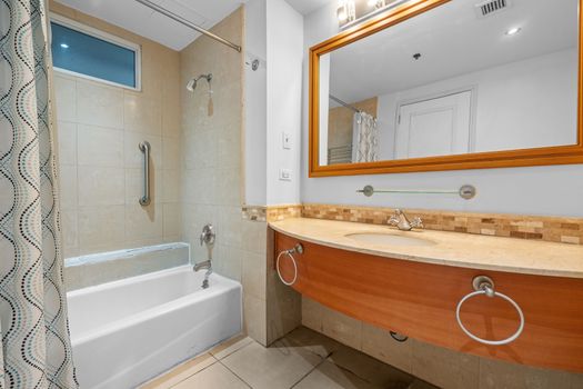 Enjoy the convenience of this bright and clean bathroom, featuring a refreshing shower and a relaxing bathtub.