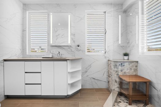 Wake up to luxury in this modern, marble-clad bathroom