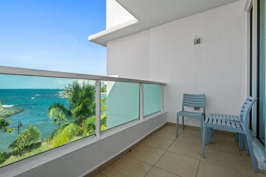This incredible balcony view showcases the rich history and vibrant natural scenery of the area, featuring the iconic fort and ocean