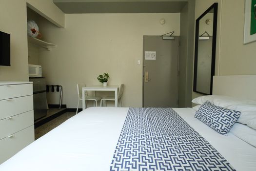 Enjoy the convenience of a studio setup, featuring a cozy sleeping area, a functional dining table for meals or work, and ample space for a comfortable stay.