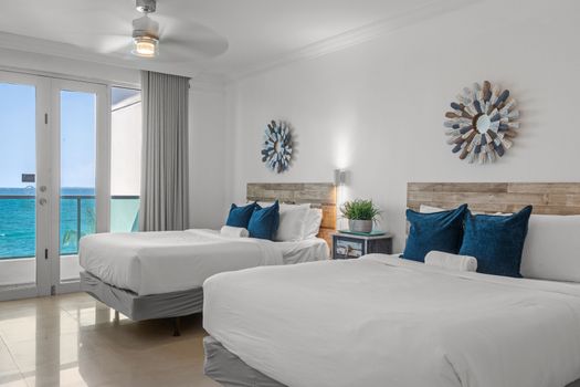 Unwind in comfort with the soothing sounds of the waves. This serene bedroom provides two cozy beds and an unparalleled oceanfront experience, perfect for couples or families.