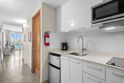 Enter a world of comfort with this fully-equipped kitchenette, perfect for preparing light meals and snacks. The clean, contemporary design creates a welcoming atmosphere for your stay.