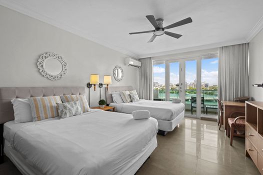 Accommodate everyone comfortably in our spacious bedroom with two individual beds. Designed for both relaxation and convenience, this room offers a peaceful haven with easy access to outdoor views, perfect for sharing memories