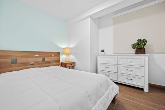 Bright and airy bedroom with comfortable bed and ambient lighting.