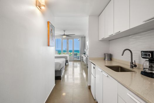 Stunning ocean view studio with direct balcony access and a convenient kitchenette. Experience comfort and breathtaking scenery.