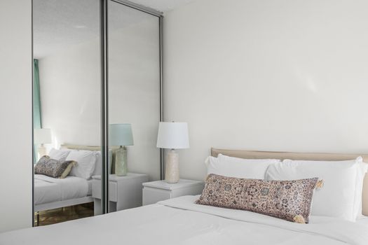 Unwind in comfort and style. The elegant headboard and thoughtful lighting create a sophisticated ambiance in this tranquil bedroom, perfect for a peaceful escape