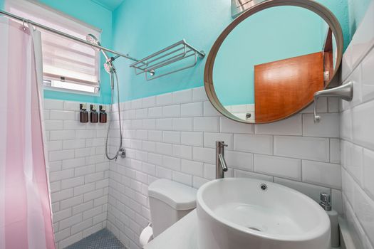 Fresh and clean: a bright bathroom with a crisp white and aqua color scheme.