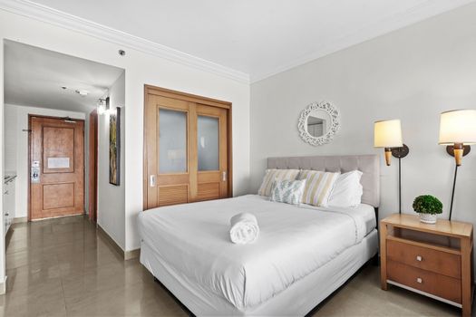 Settle into ultimate comfort in this inviting bedroom featuring a plush queen-sized bed. With ample storage in the stylish sliding door wardrobe, you'll feel right at home and ready to relax after a day of exploring.