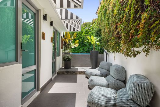 Our charming façade invites you to unwind. Relax by the pool, work out with a view in our outdoor gym, and let the cute signage guide your exploration
