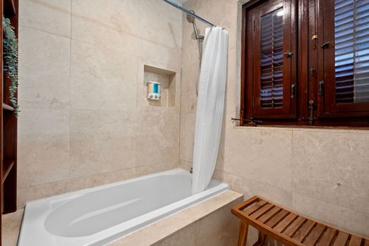 This tranquil bathroom, complete with a soothing bathtub, is the perfect place to relax and unwind after a long day.