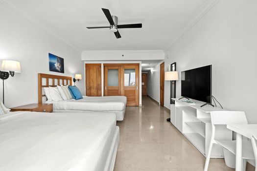 Your perfect retreat: well-appointed beds with artistic touches and direct access to outdoor views.