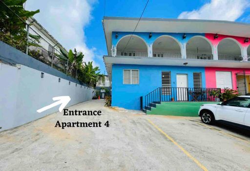 Step into your inviting retreat! Our vibrant house entrance leads directly to your private Apartment 4, promising a warm welcome to your Caribbean escape.