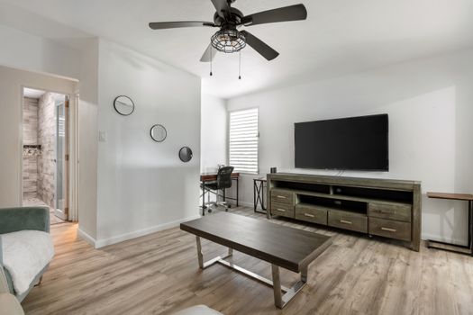 Cozy living room with a large flat-screen TV for entertainment.