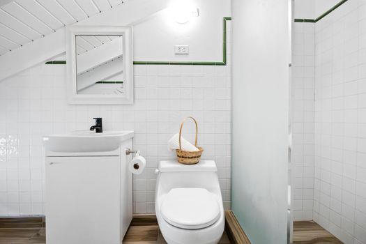 Freshen up in style in this bright, white bathroom with  shower.