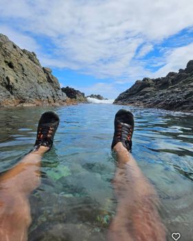 Experience a refreshing dip in a secluded natural pool, embraced by dramatic rock formations and the open sky. Adventure awaits