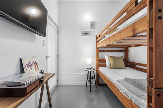 Discover minimalist comfort in our modern bunk bed room, designed for simplicity and efficiency.