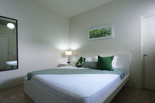 Immerse yourself in the calming atmosphere of this bedroom. The soft lighting and comfortable furnishings create an ideal setting for unwinding after your day's adventures.