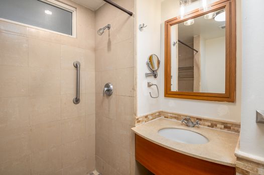 Refresh and rejuvenate in our clean, contemporary bathroom featuring a spacious shower and elegant vanity.