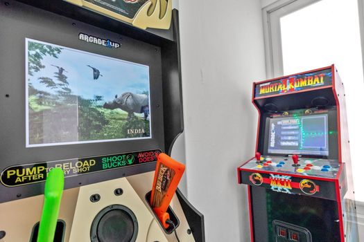 Stylish gamer’s paradise with vintage arcade machines – book your fun escape now.